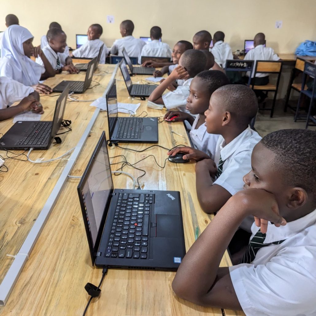 Students learning computer skills during ElimuTech Digital Innovation Club session at Akeri Secondary School in Arusha